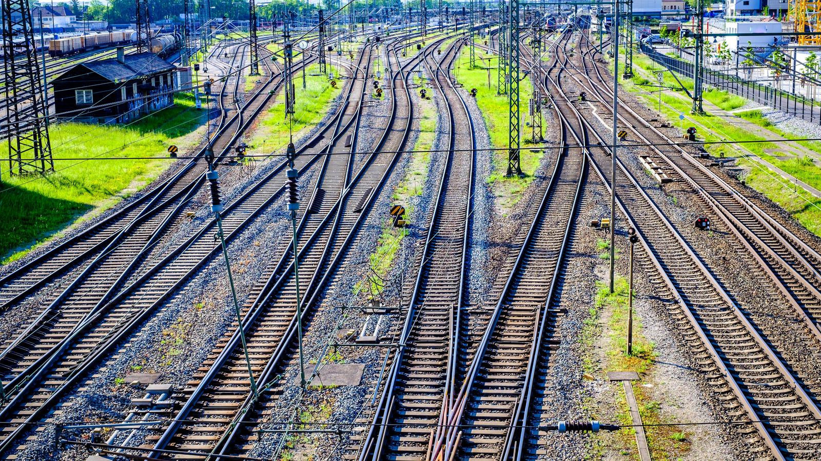 Nebeneinanderliegende Eisenbahngleise verschlingen paarweise ineinander.